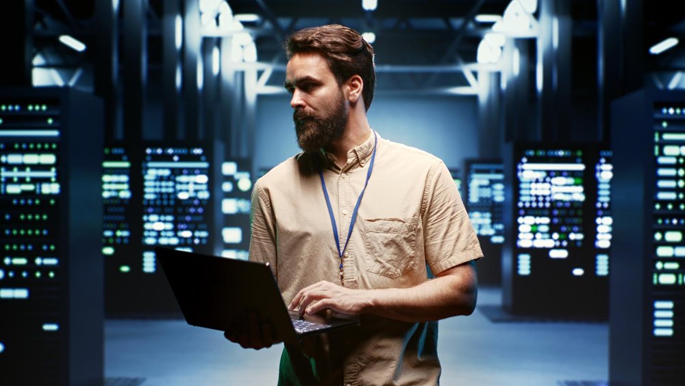 Secure and reliable web hosting services workspace with developers managing servers, dashboards, and performance optimization in a modern office environment